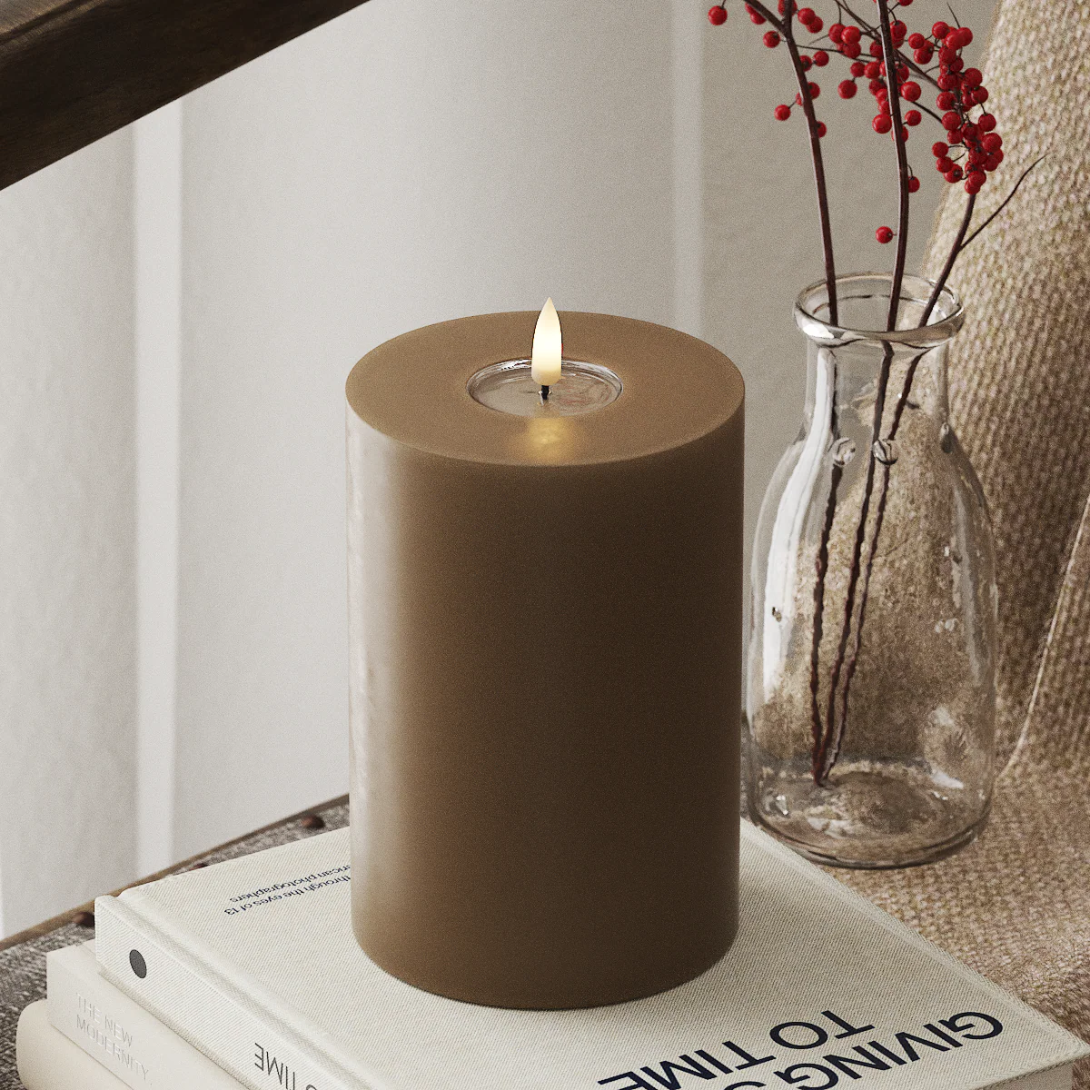 realistic caramel LED candle glowing softly in a warm winter interior scene
