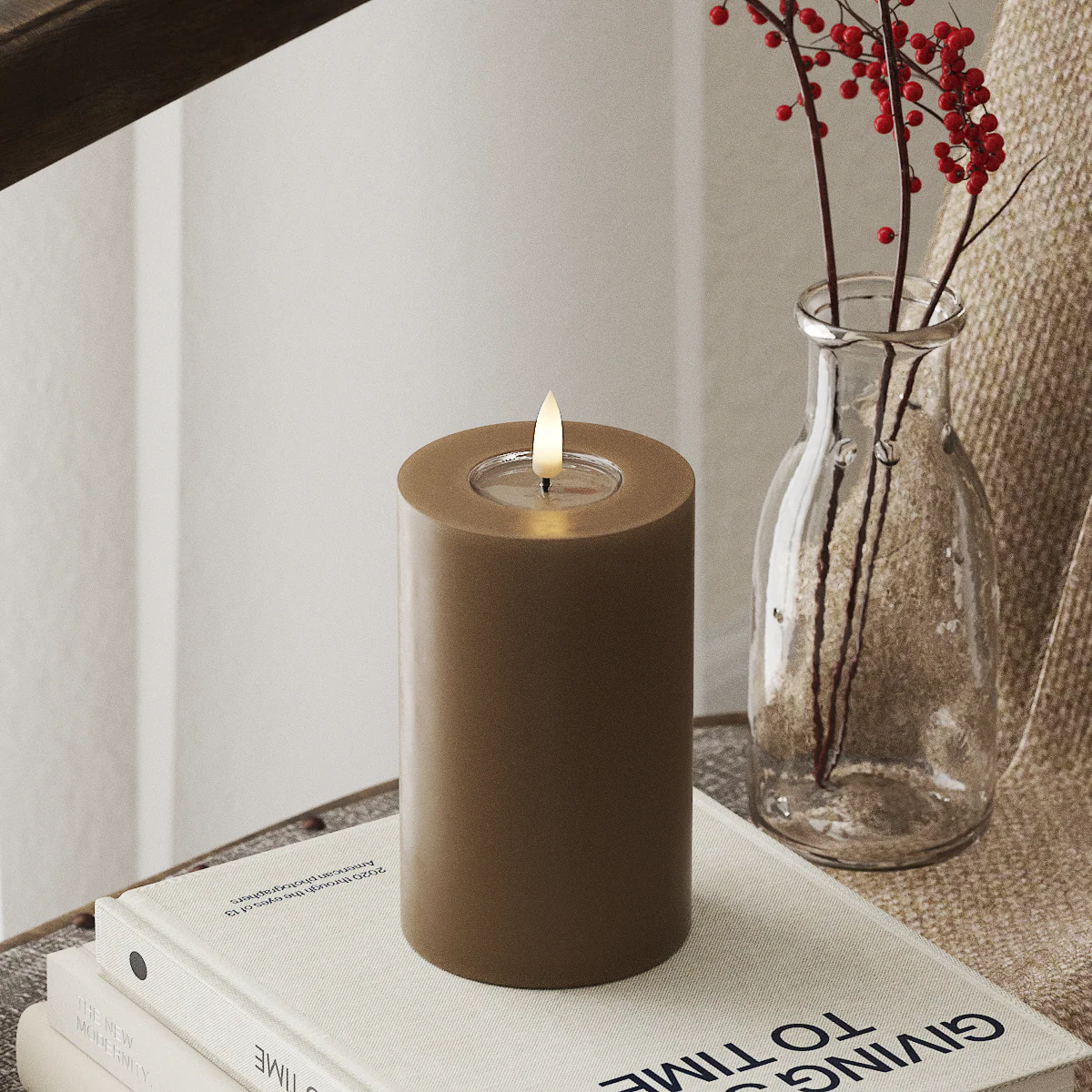 cosy winter interior with lifelike caramel LED candle casting warm ambient light
