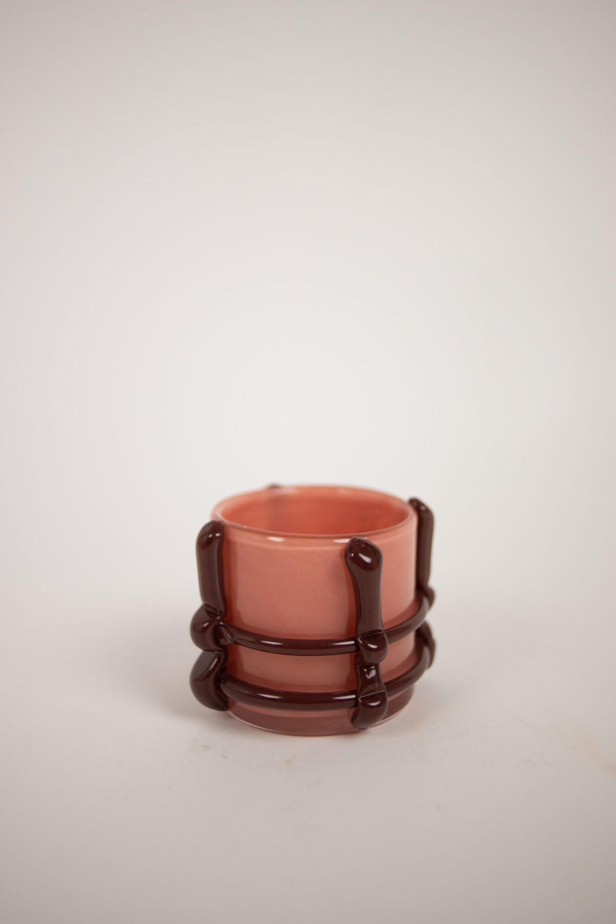 Caramel pink glass votive with dark brown wrapped bands by Olsson & Jensen
