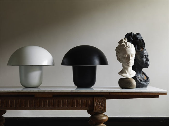Carl-Johan mushroom table lamps by Olsson & Jensen in white and black styled on a wooden console