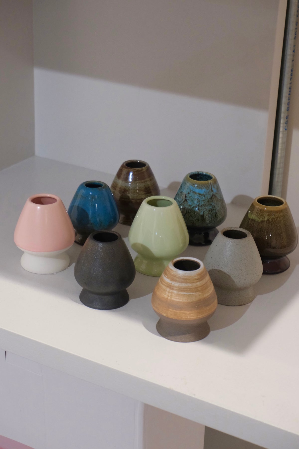 collection of ceramic chasen naoshi matcha whisk stands in multiple colours including eco blue
