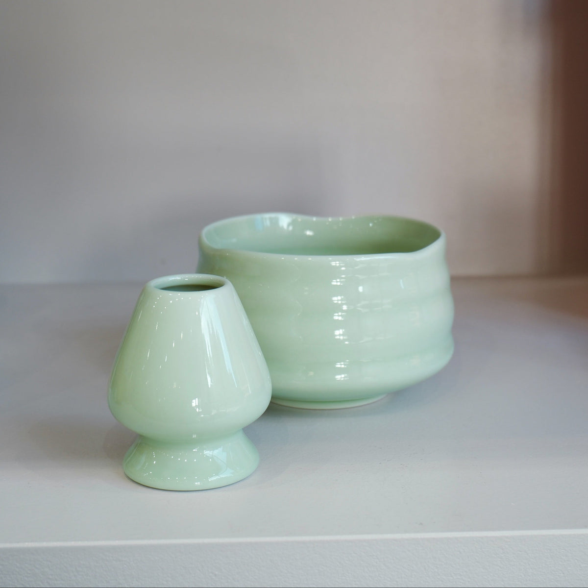 pastel green chasen naoshi matcha whisk stand styled with matching ceramic bowl

