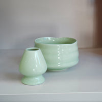 pastel green chasen naoshi matcha whisk stand styled with matching ceramic bowl
