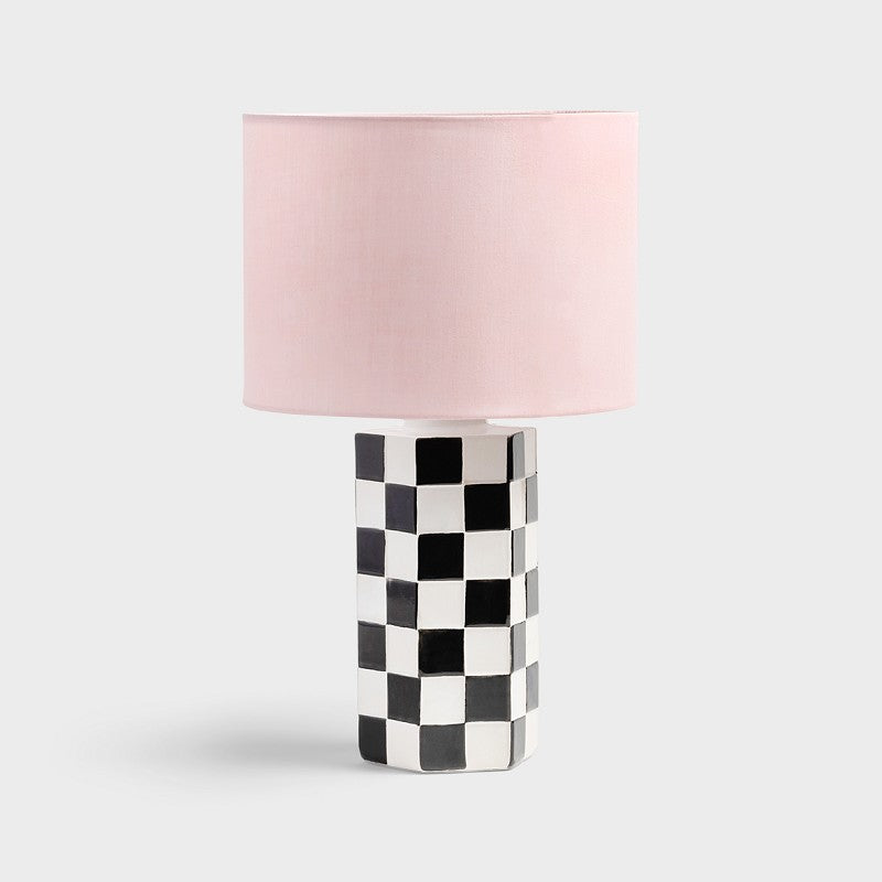Check table lamp with black and white chequered stoneware base and pink shade by &Klevering