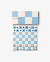 Top-down view of open blue and beige chessboard