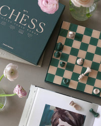 Elegant chess set on side table in light living room