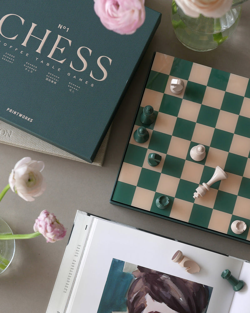 Elegant chess set on side table in light living room