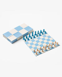 Blue and beige chess set with foldable board and wooden pieces