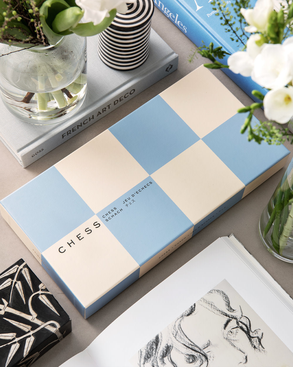Blue and beige chess set styled with coffee table decor