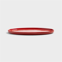 Side view of the slim red Chiquito porcelain tray with low rim