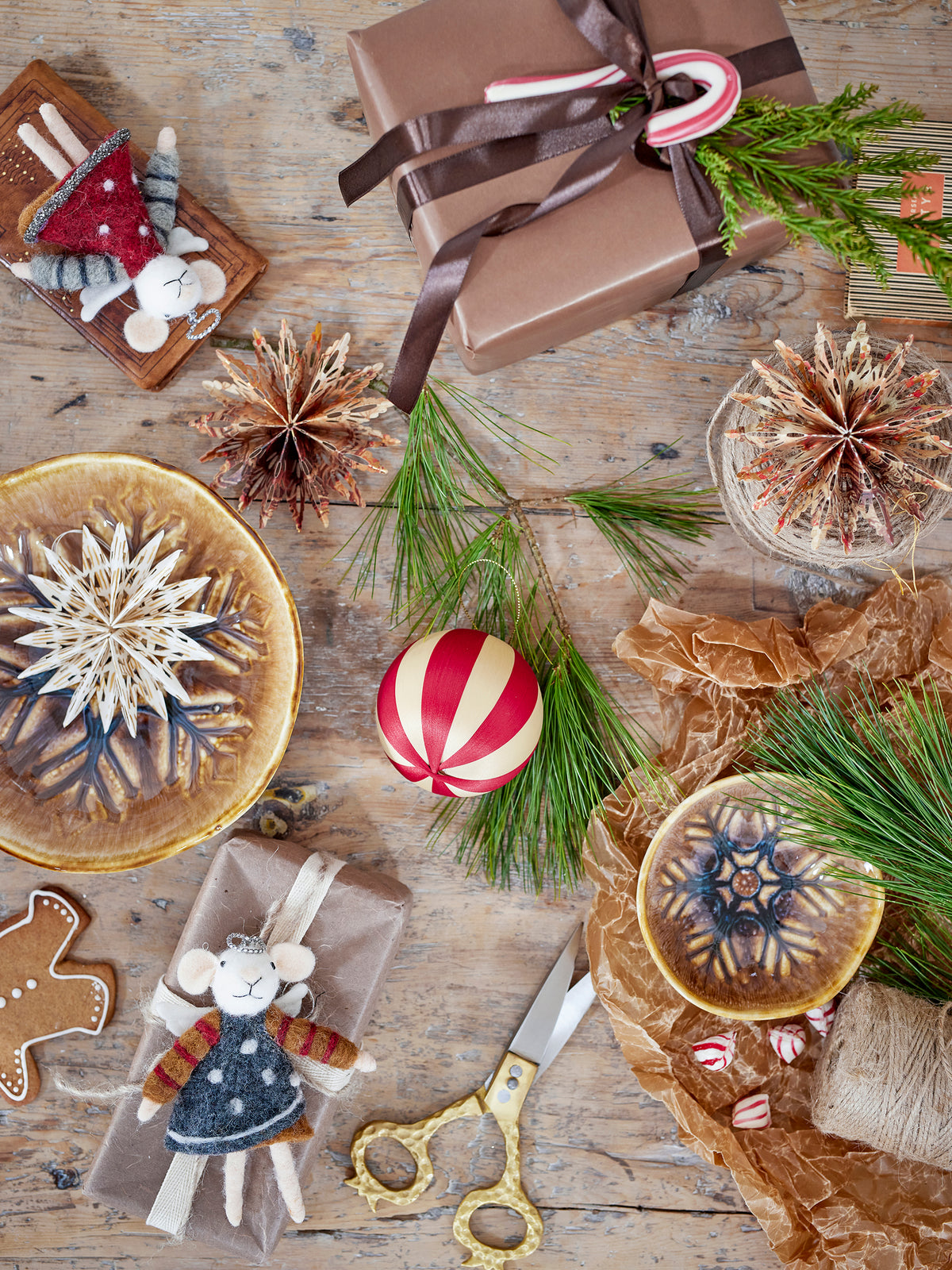 Wool mouse ornaments with red and grey dresses on gift-wrapping table