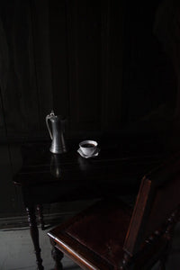 Claire cup and saucer by Olsson & Jensen in a moody, dark interior
