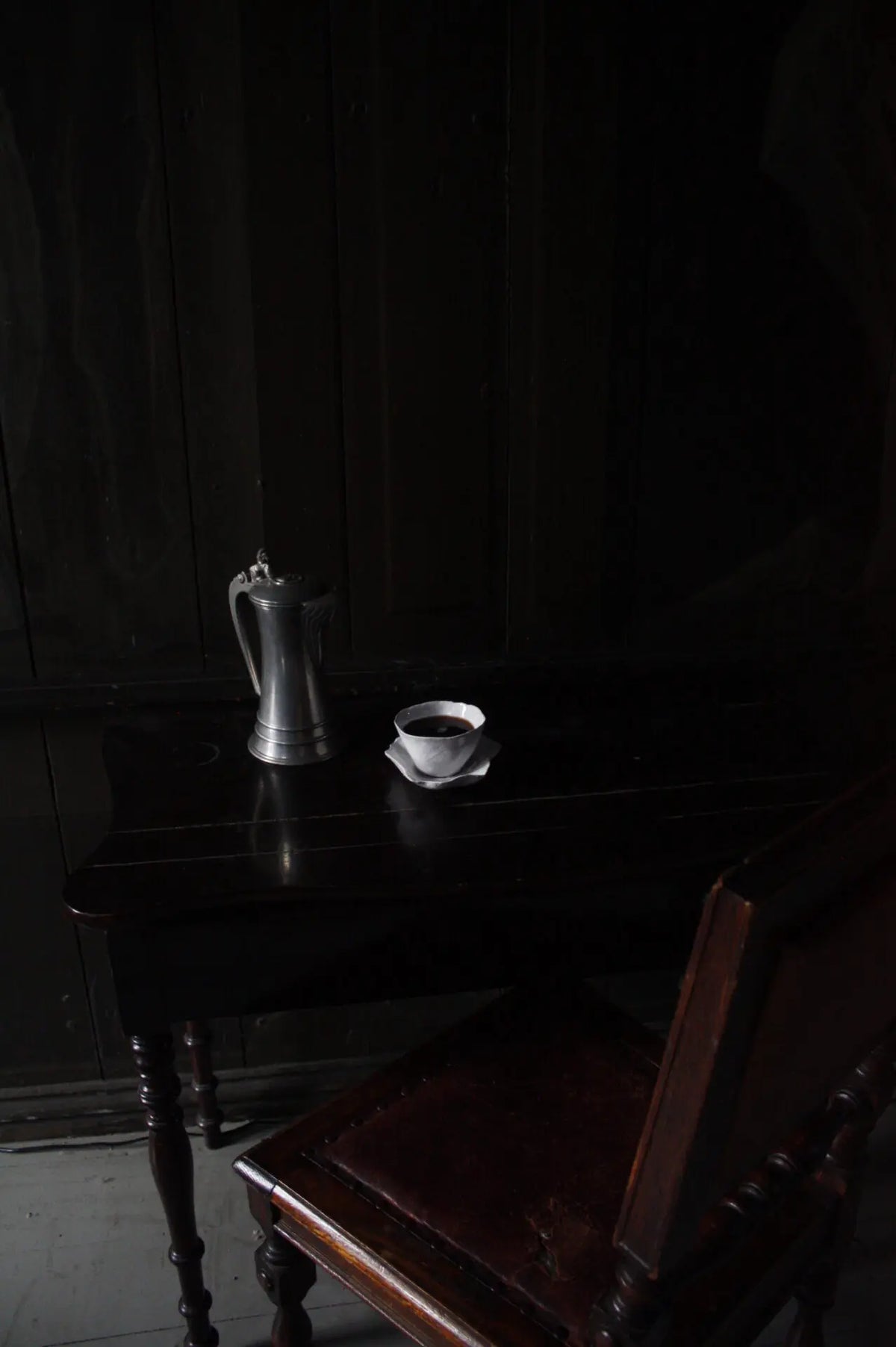 Claire cup and saucer by Olsson & Jensen in a moody, dark interior