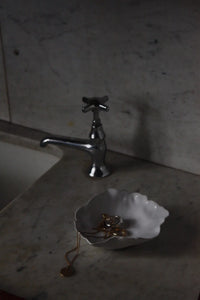 Claire ceramic saucer by Olsson & Jensen styled beside a stone sink