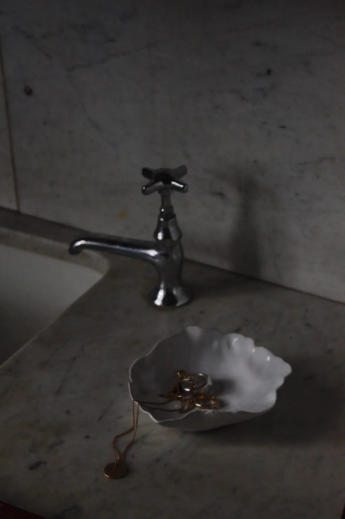 Claire ceramic saucer by Olsson & Jensen styled beside a stone sink