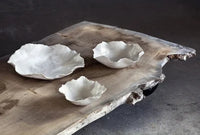 Claire white ceramic bowls by Olsson & Jensen styled on a rustic wooden surface