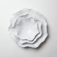 Stack of Claire white handmade ceramic bowls with wavy edges by Olsson & Jensen