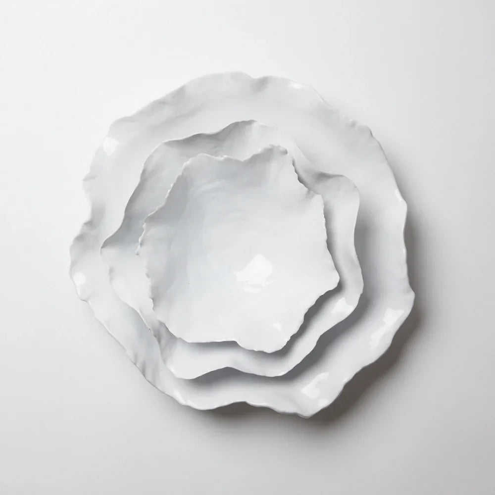 Stack of Claire white handmade ceramic bowls with wavy edges by Olsson & Jensen