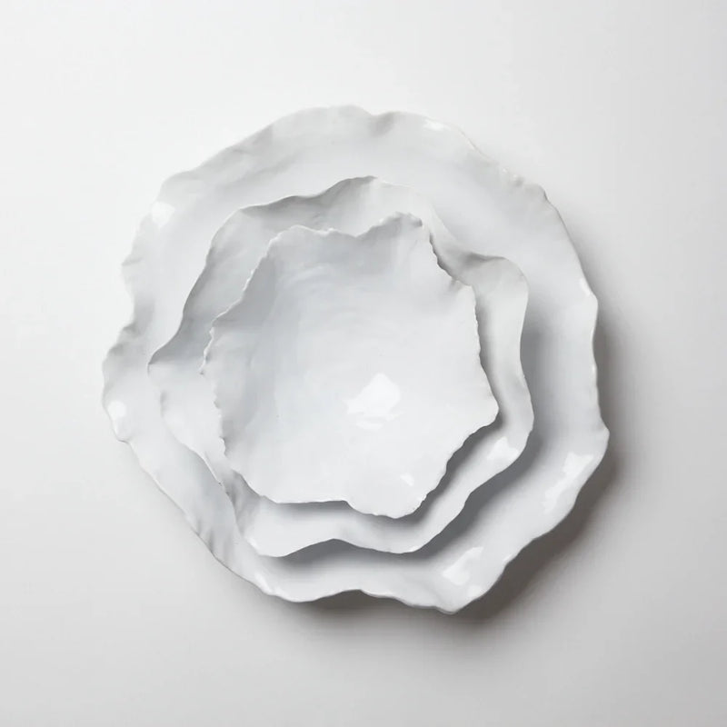 Stack of Claire white handmade ceramic bowls with wavy edges by Olsson & Jensen
