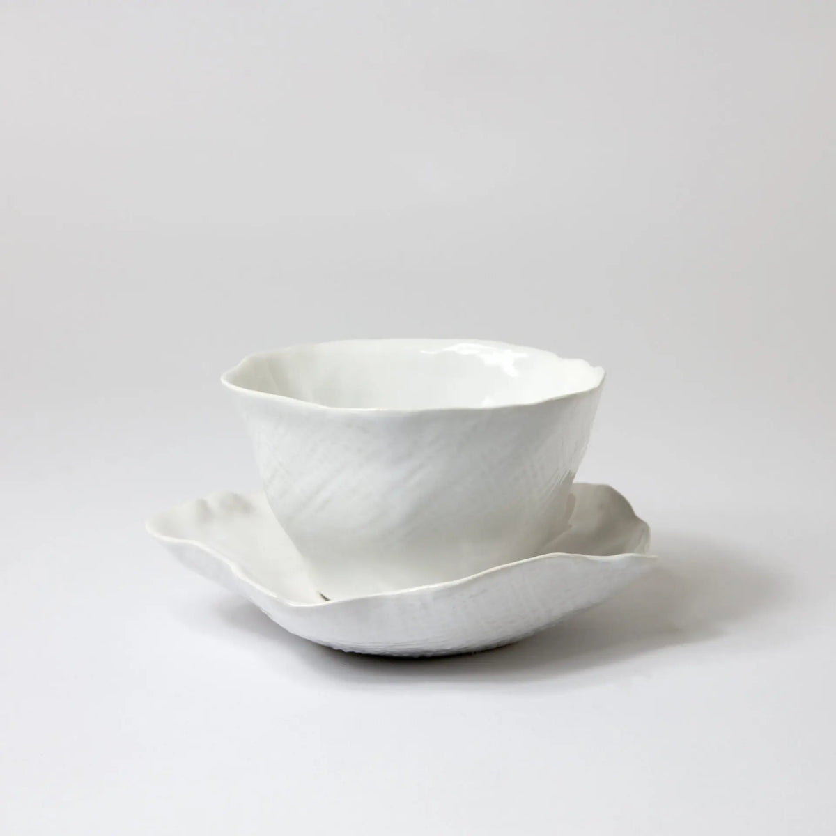 Claire white handmade ceramic cup and saucer with a wavy edge by Olsson & Jensen
