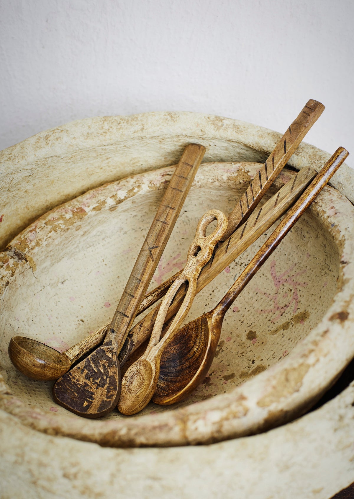 natural coconut spoons styled in rustic stone bowl