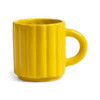 Yellow mug with a ribbed texture on a white background