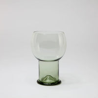 Como clear drinking glass with a rounded bowl and green glass foot by Olsson & Jensen