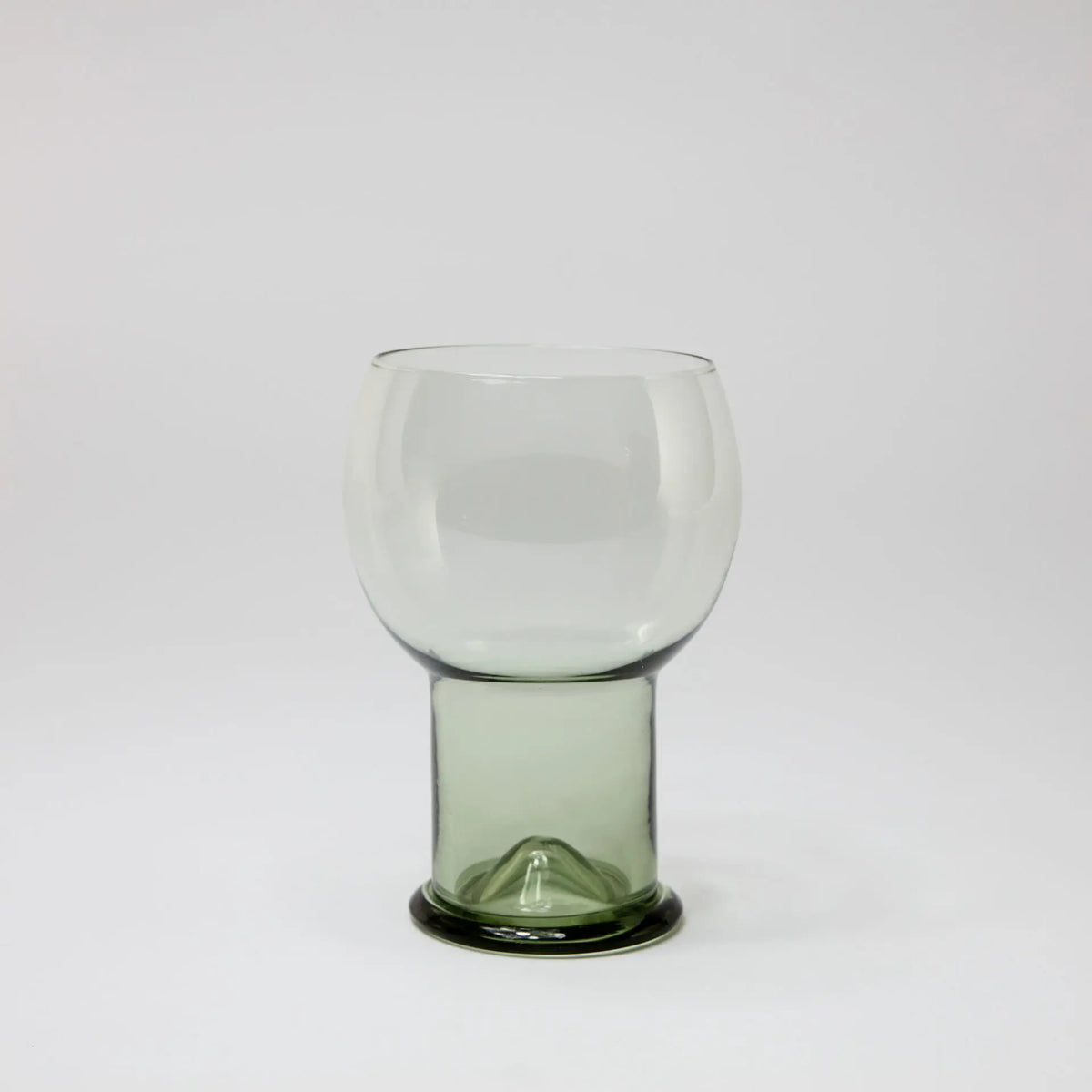 Como clear drinking glass with a rounded bowl and green glass foot by Olsson & Jensen