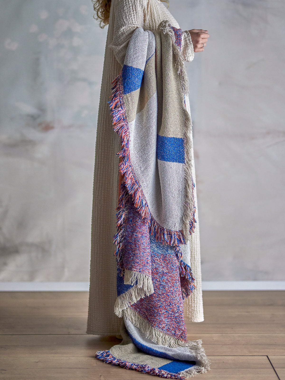 Clarita Throw by Bloomingville draped over arm in soft natural setting