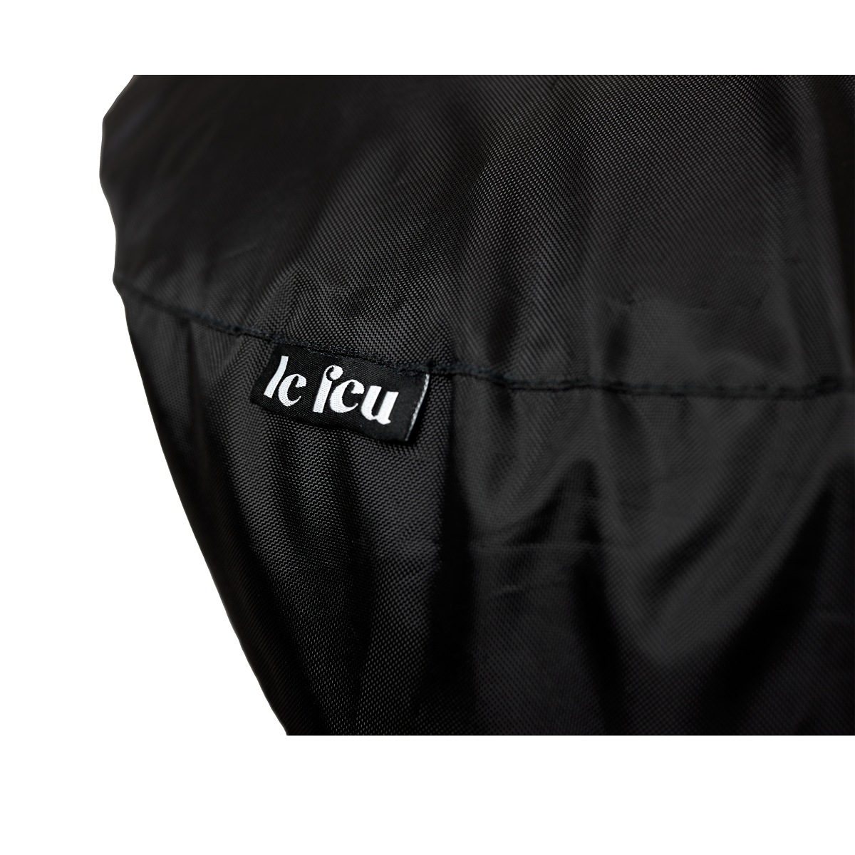 Close-up of the Le Feu logo label on the black Dome Outdoor Cover