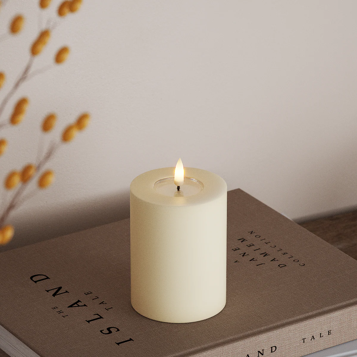 small cream LED candle with realistic flame styled on a book for cosy autumn décor
