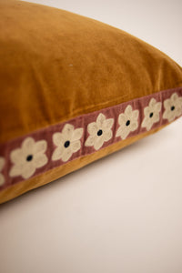 Close-up of the embroidered daisy trim on the Daisy camel cushion by Olsson & Jensen