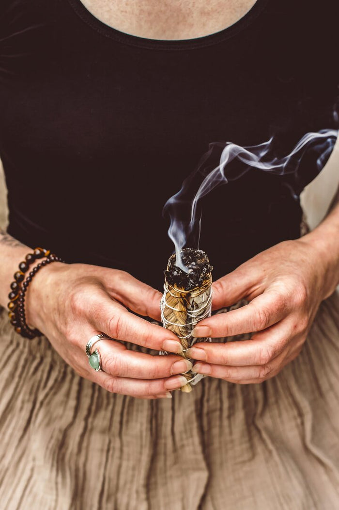 Handmade smudge stick with white sage and braided sweetgrass