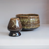 eco green ceramic chasen naoshi matcha whisk stand beside matching bowl
