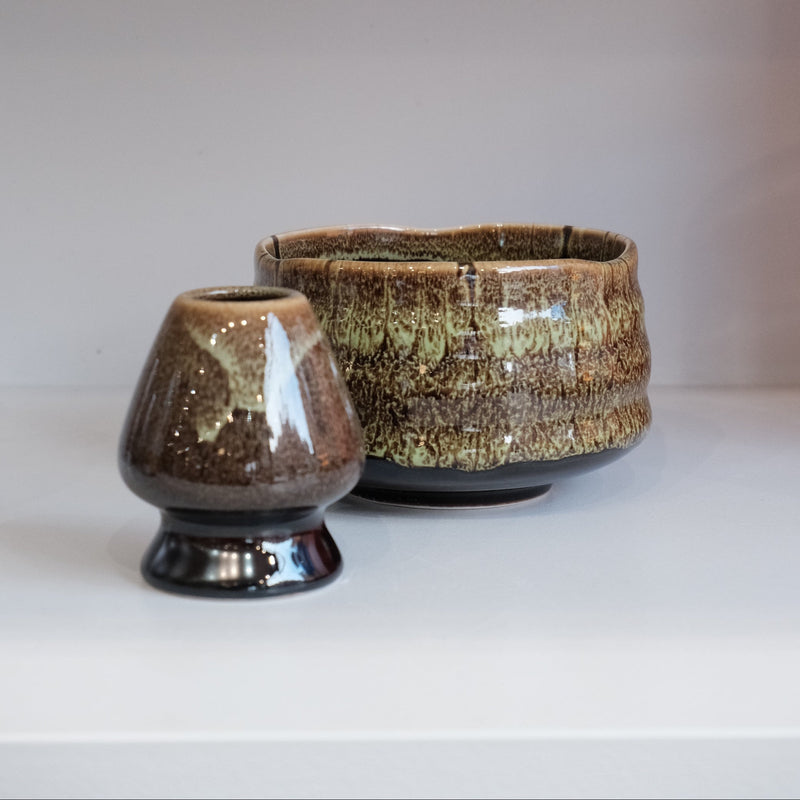 eco green ceramic chasen naoshi matcha whisk stand beside matching bowl
