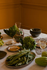 Eden olive green bowls by Olsson & Jensen on a dinner table with seasonal vegetables