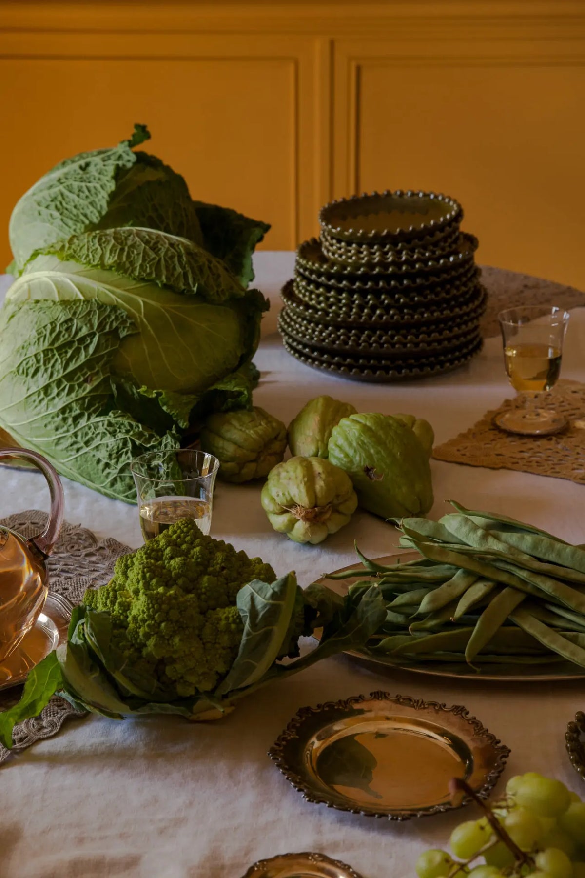 Eden olive green stoneware by Olsson & Jensen on a dinner table with seasonal vegetables