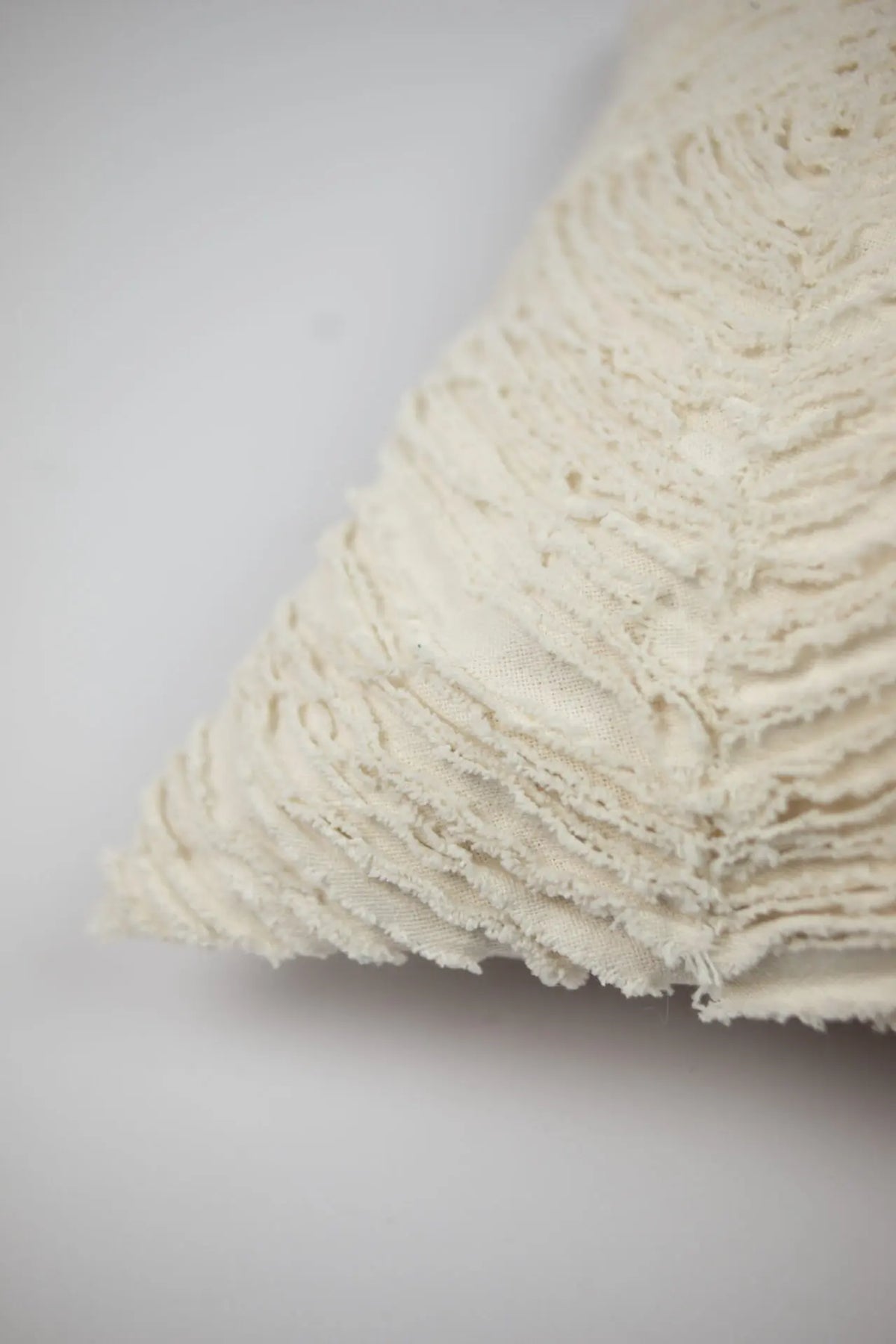Close-up of the raw-edged wave texture on the Elba 50x90 cushion by Olsson & Jensen