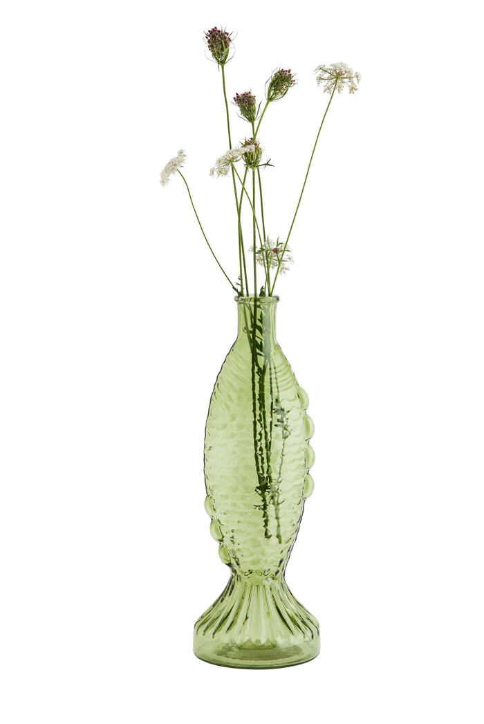 green fish-shaped glass vase with textured scales styled with delicate stems
