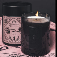 2 jars stood on a rose coloured bandana on eof which is alight and both containing the fischersund no 8 scented candle