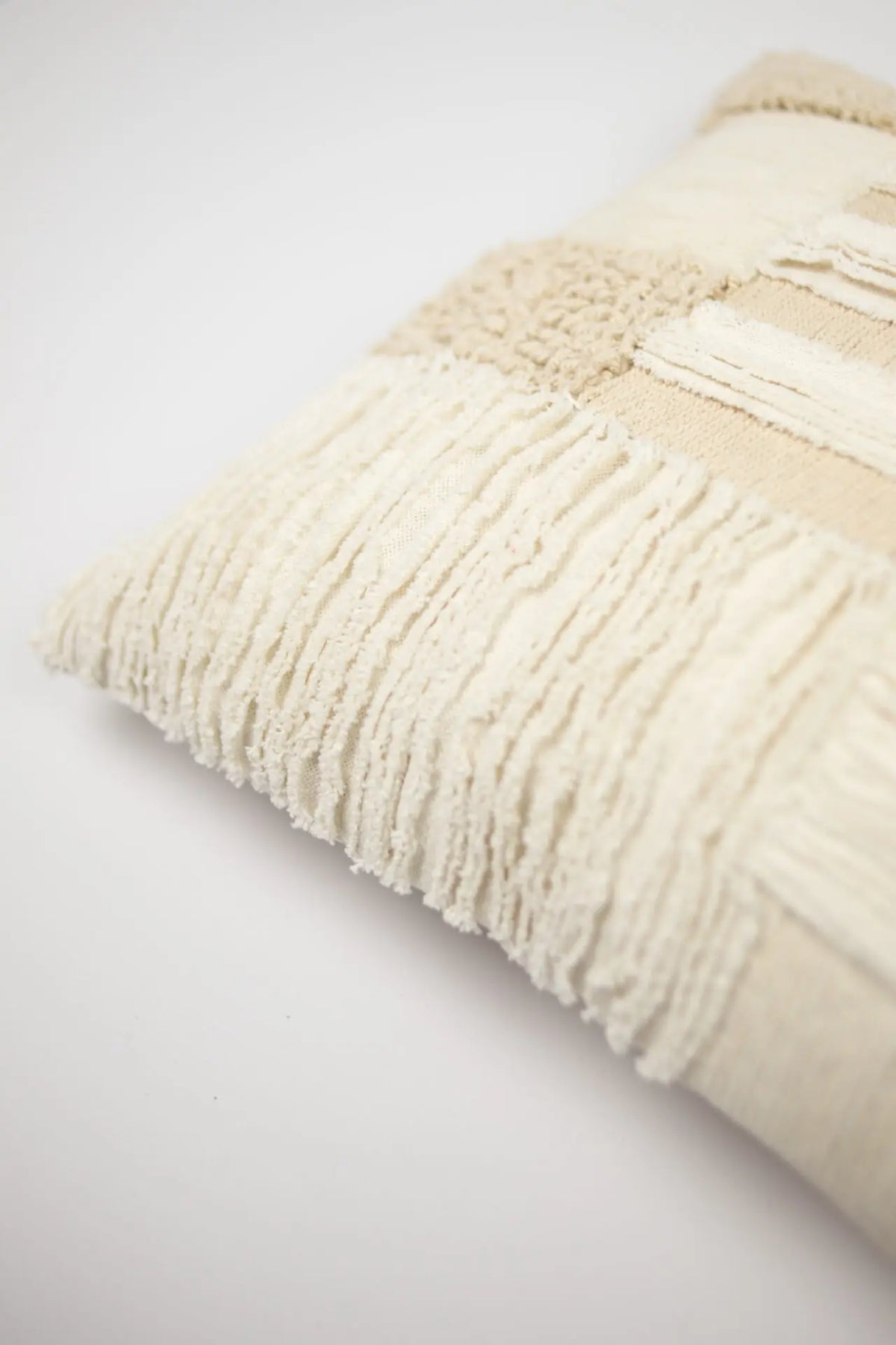 Corner detail of the Franca cream patchwork cushion by Olsson & Jensen