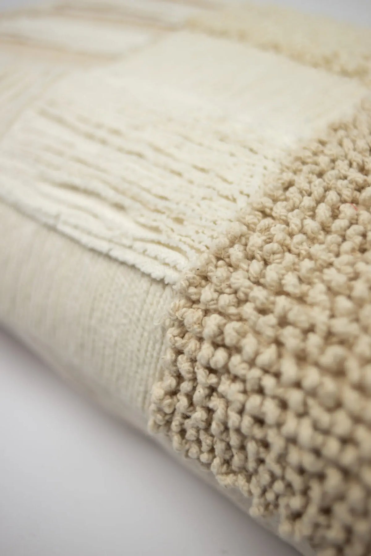 Close-up of the knotted and fringed cotton panels on the Franca cushion by Olsson & Jensen