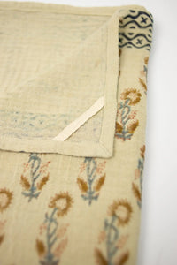 Close-up of the hand block printed flowers and border on the Franchette kitchen towel by Olsson & Jensen