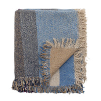 Folded fringed throw in blue and neutral tones
