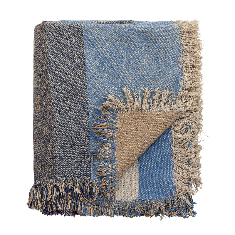 Folded fringed throw in blue and neutral tones