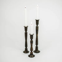 Set of three Gill handmade dark iron taper candlesticks by Olsson & Jensen with white candles