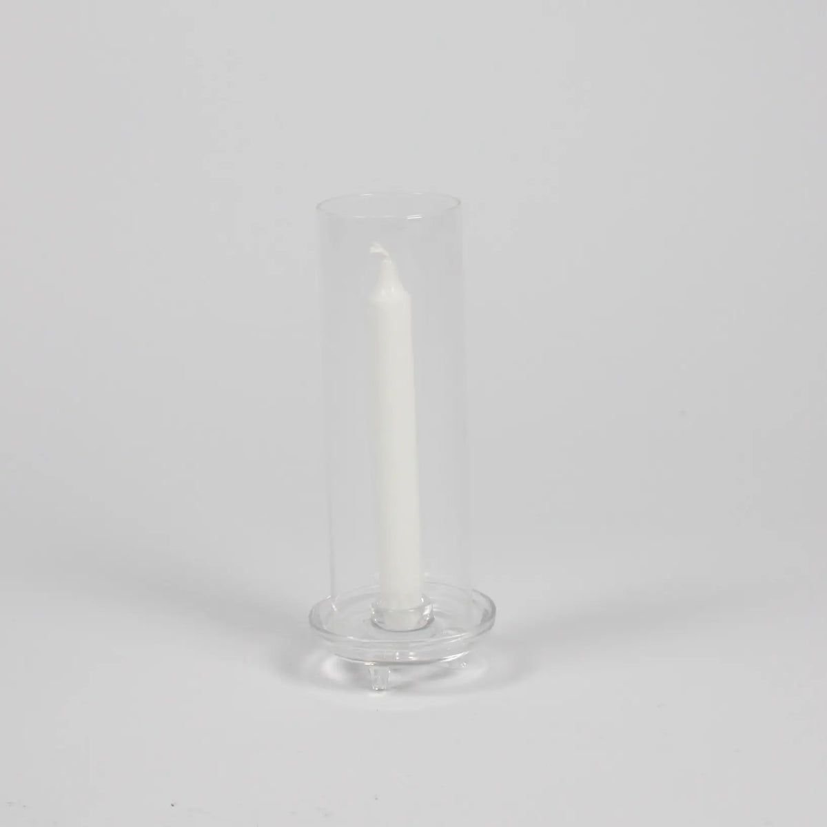 Gilly clear glass hurricane candle holder by Olsson & Jensen with a white taper candle