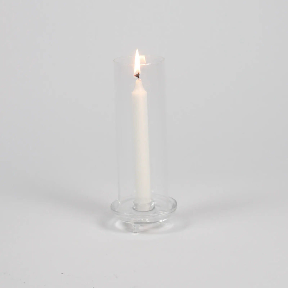 Gilly glass hurricane by Olsson & Jensen with a lit taper candle