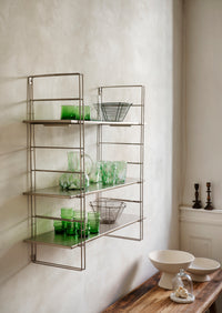 glass dome with marble base styled on wooden counter in calm nordic kitchen