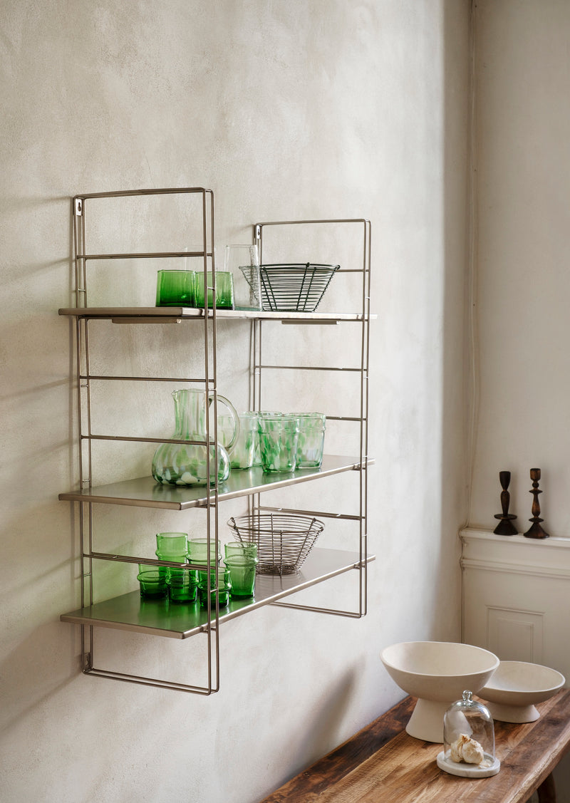 glass dome with marble base styled on wooden counter in calm nordic kitchen